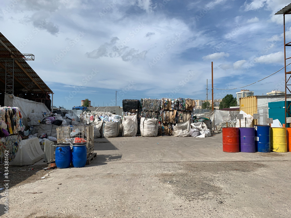 Separate garbage collection. Garbage warehouse. Pressed waste, barrels, containers. Waste recycling concept.