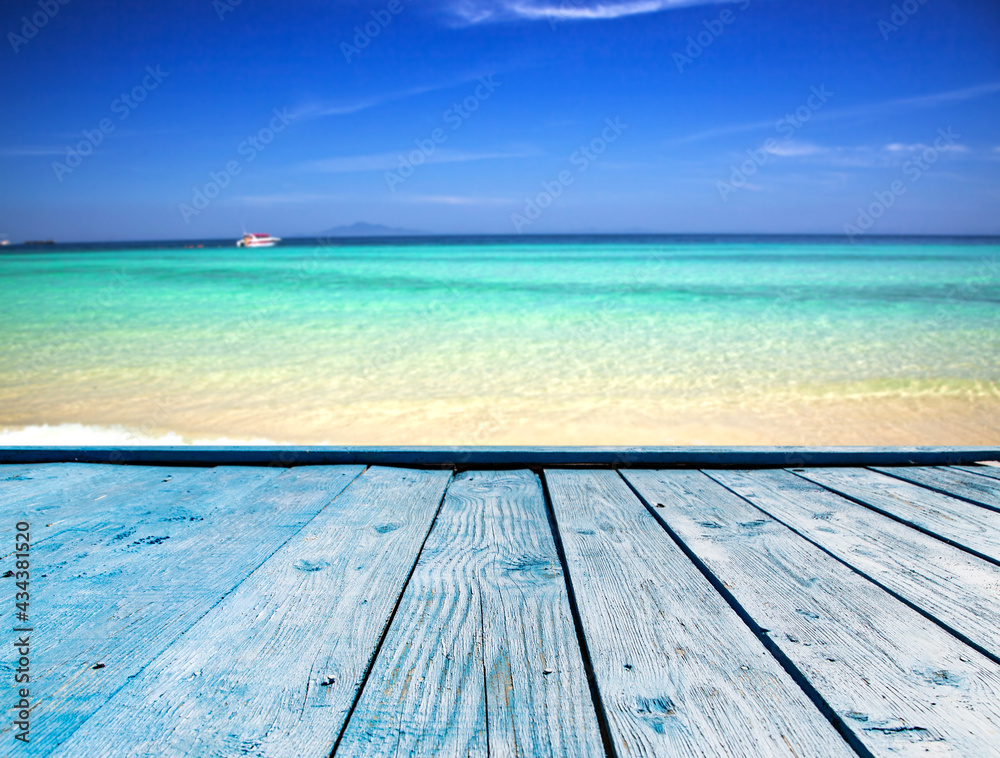 blue wooden plank and beach with clear blue water