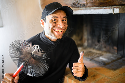 Fotografie, Tablou Young chimney sweep portrait in a house giving thumbs up