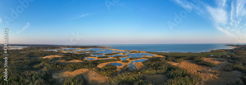 Aerial panoramic view to the amazing sunset colored coastal seascape with the complex lagoon archipelago pattern on Saaremaa island, Estonia