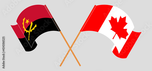 Crossed and waving flags of Angola and Canada