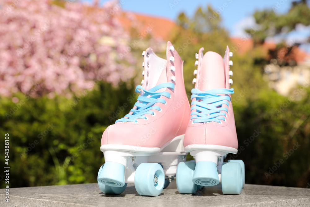 Stylish pink roller skates outdoors on sunny day Stock Photo | Adobe Stock
