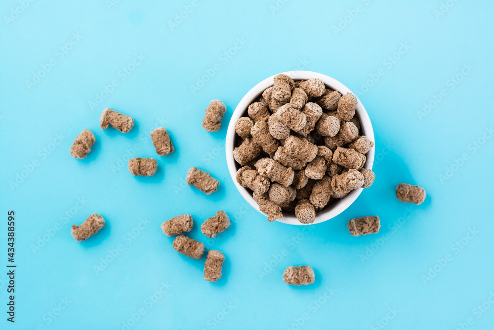 Rye bran in a bowl and on a table on a blue background. Diet and cleansing the body with fiber. Top view Rye bran in a bowl and on a table on a blue background. Diet and cleansing the body with fiber. Top view