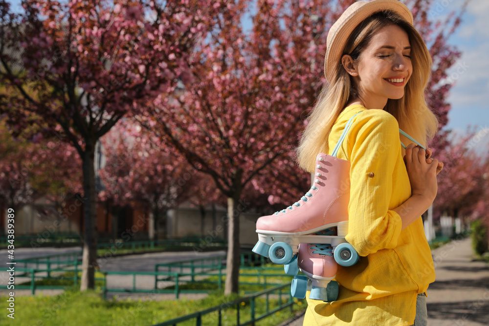 Young woman with roller skates in spring park Young woman with roller skates in spring park