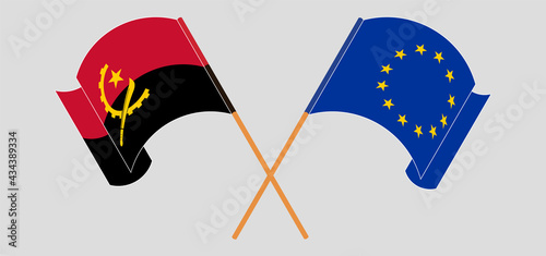 Crossed and waving flags of Angola and the European Union