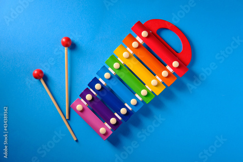 Multicolored xylophone on blue background, top view