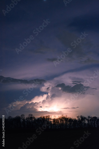 Thunderstorm at night with starry sky