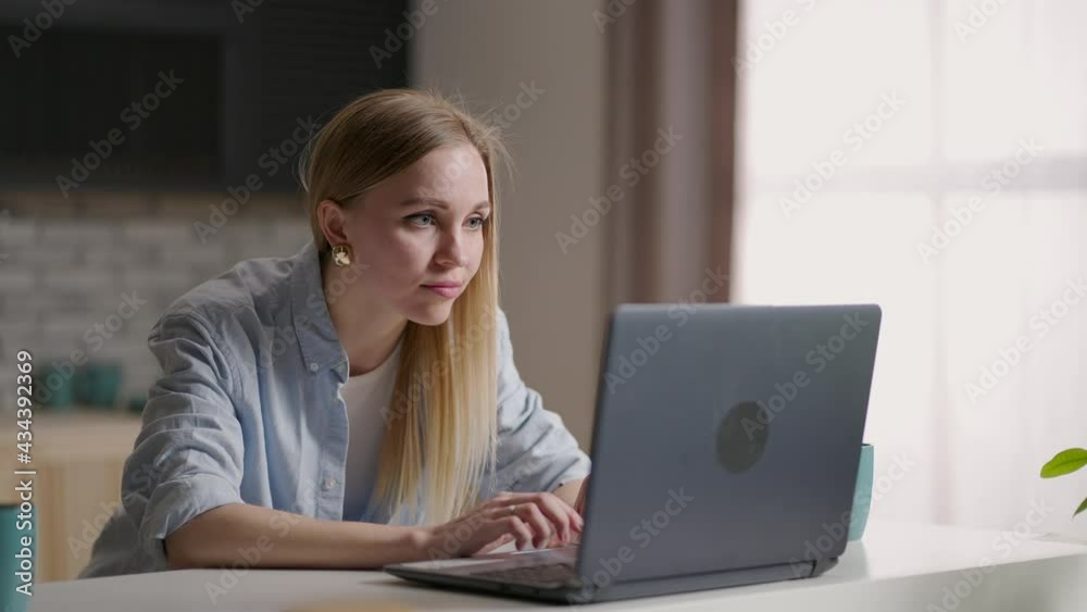Mobile Office at home. Young woman sitting in kitchen at home working using on laptop computer. Lifestyle girl studying or working indoors. Freelance business quarantine concept Mobile Office at home. Young woman sitting in kitchen at home working using on laptop computer. Lifestyle girl studying or working indoors. Freelance business quarantine concept