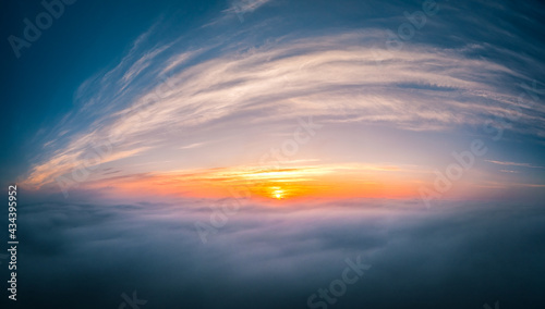 Beautiful warm sunrise over the puffy clouds. Above the cloudy sky. Drone footage.  © Viesturs