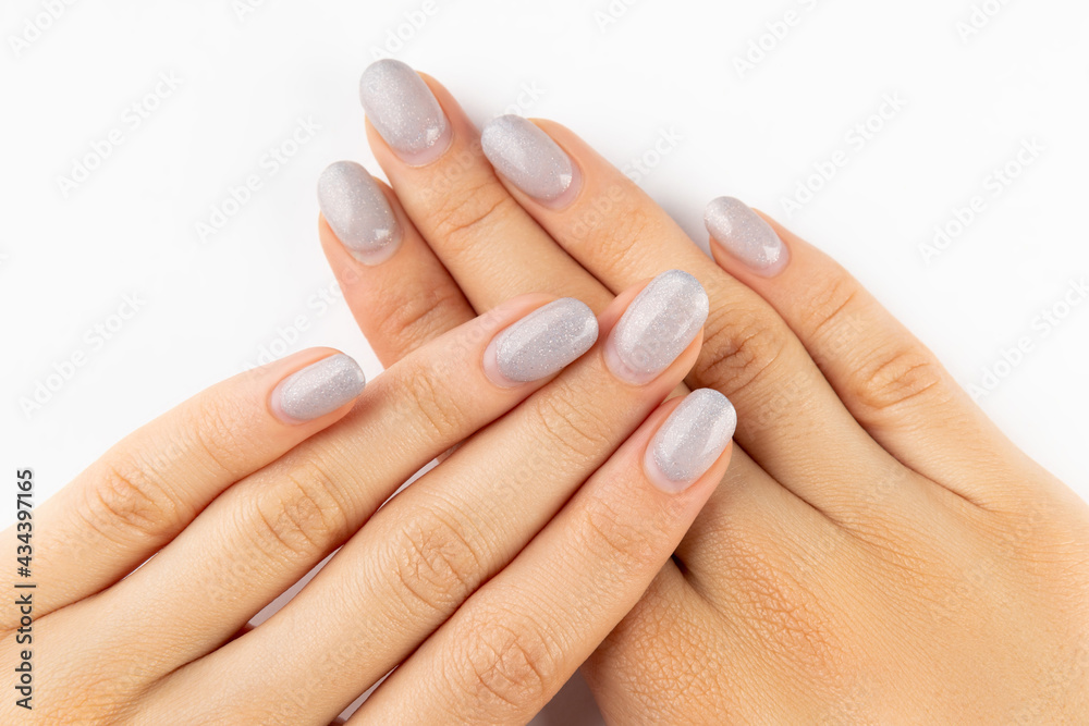 Womans hands with grown manicure on white background with copy space Womans hands with grown manicure on white background with copy space