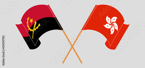 Crossed and waving flags of Angola and Hong Kong