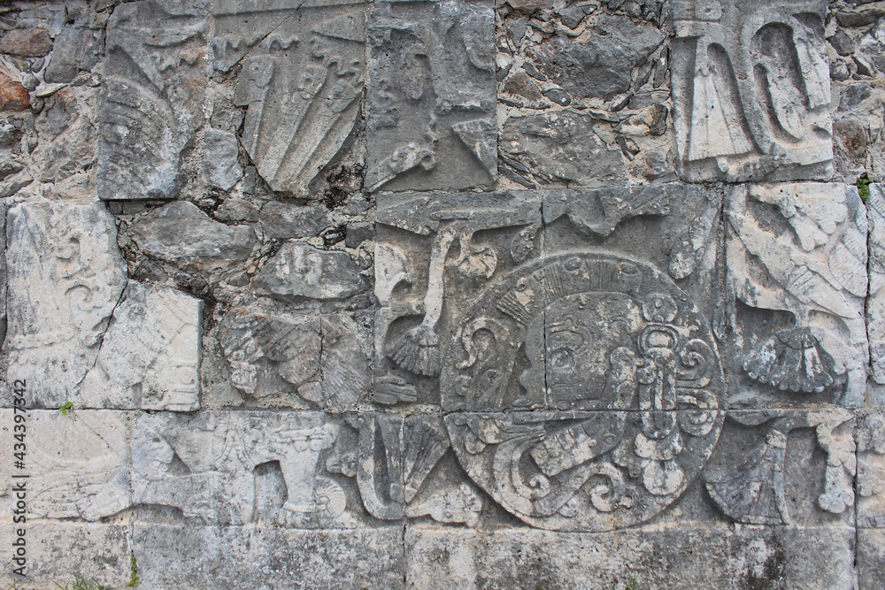 Detail of Mayan wall carving on the territory of Chichen Itza, Yucatan, Mexico. Ancient Mayan stone reliefs at Chichen Itza ruins, mexican archaeological site.