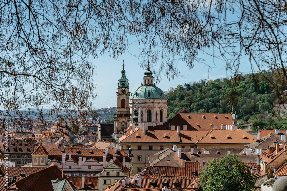 Prague panorama,Czech Republic.Spring view of Church of Saint Nicholas,Lesser town with historical buildings and red roofs.Amazing European cityscape.Sunny day in the city.Travel architecture concept.