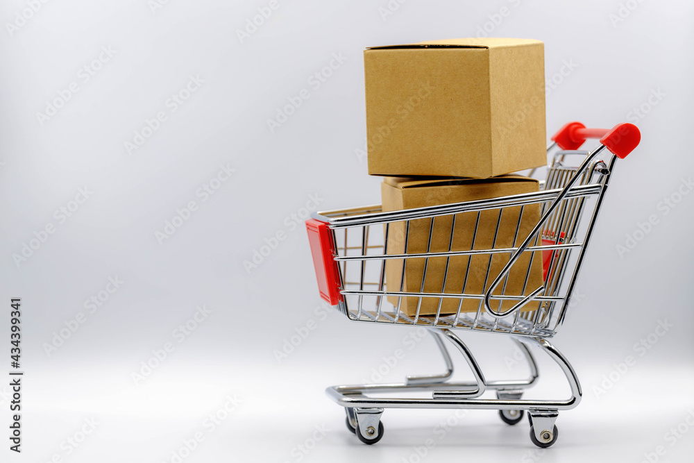 Online shopping and shipping concept, Shopping cart and post boxes on white background, Mini red blank trolley with free copy space, Business and financial background.