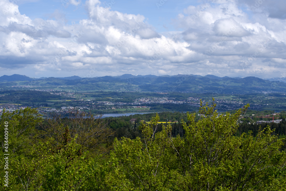 Landscape with mountains in the background seen from wooden lookout named Loorenkopfturm (Loorenkopf tower). Photo taken May 18th, 2021, Zurich, Switzerland.
