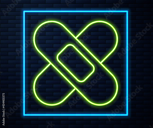 Glowing neon line Crossed bandage plaster icon isolated on brick wall background. Medical plaster, adhesive bandage, flexible fabric bandage. Vector