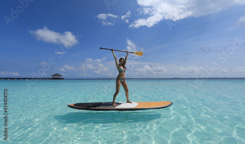 SUP surfing girl in Maldives © serikbaib