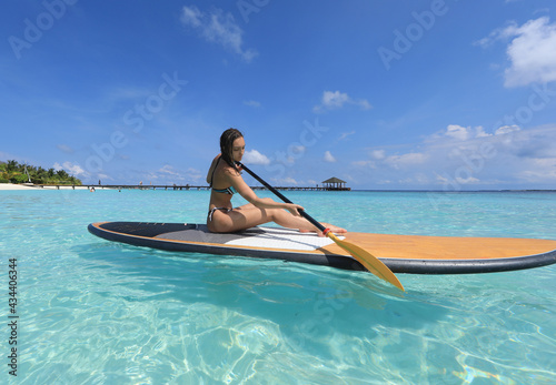 SUP surfing girl in Maldives