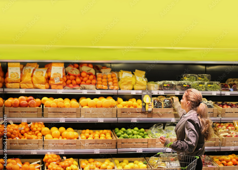 Woman buying fruits and vegetables at the market