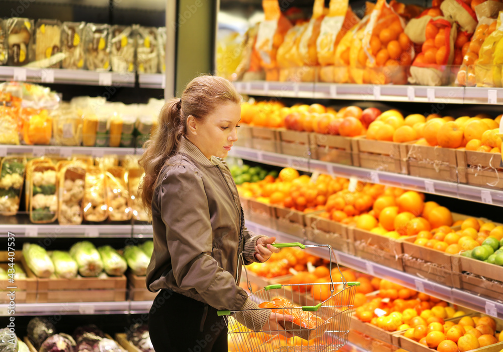 Woman buying fruits and vegetables at the market