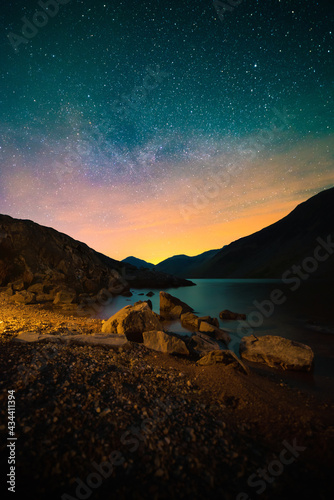 A starry night sky over Scafell Peak & Wast Water in Lake District National Park, Cumbria, UK