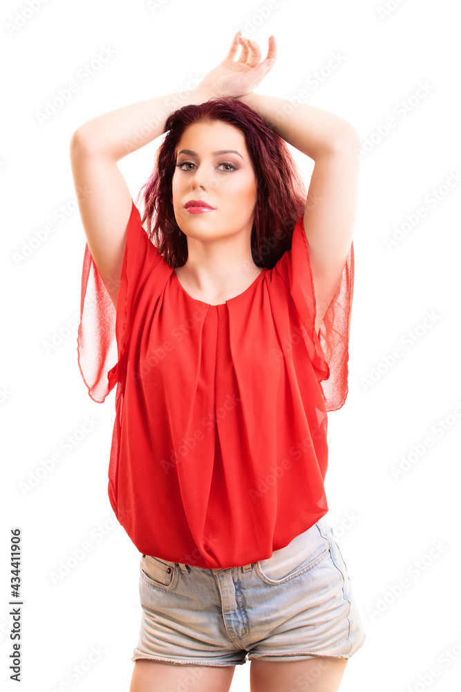 Redhead woman in summer outfit looking sensually to the camera