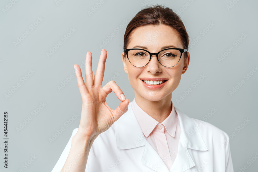 Portrait of a happy female doctor showing the OK sign Portrait of a happy female doctor showing the OK sign