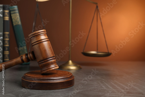 Wooden gavel on grey table, space for text. Law concept