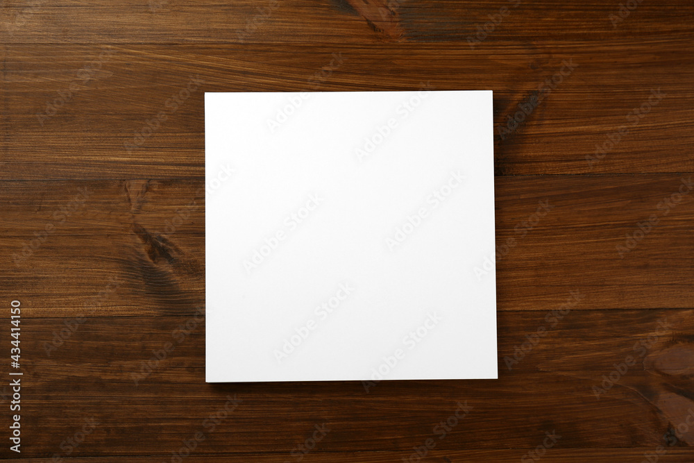 Blank paper sheet on wooden table, top view. Brochure design Blank paper sheet on wooden table, top view. Brochure design