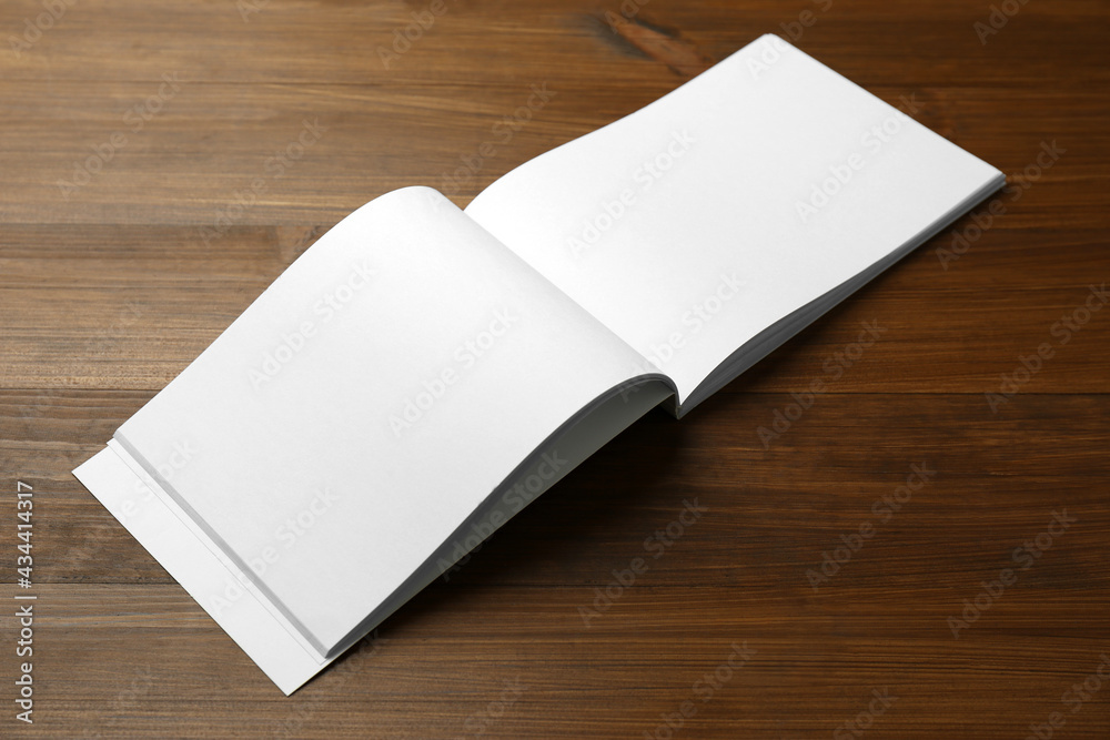 Open blank paper brochure on wooden table. Mockup for design Open blank paper brochure on wooden table. Mockup for design