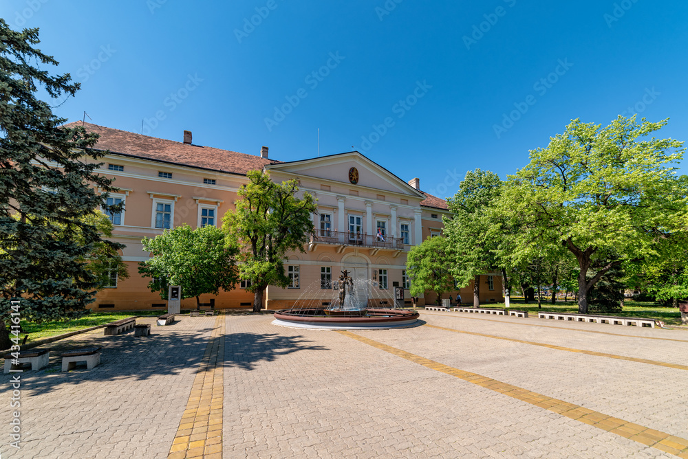 Kikinda, Serbia - July 26, 2019: National Museum building and beautiful fountain with sculpture 