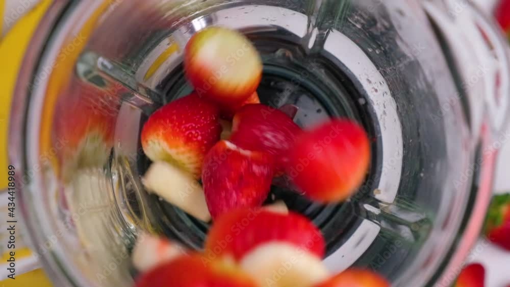 Cooking smoothie or strawberry and banana milkshake in blender. top