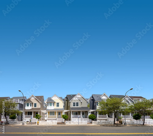 row of suburban homes street and sidewalk spring summer season