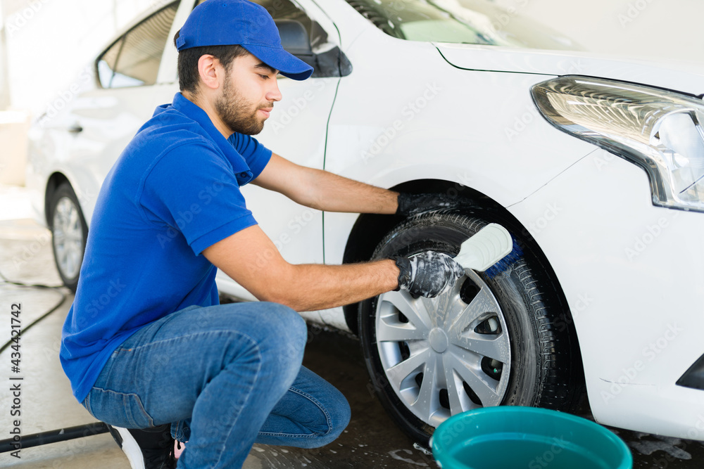 Handsome employee at the auto detail service Handsome employee at the auto detail service