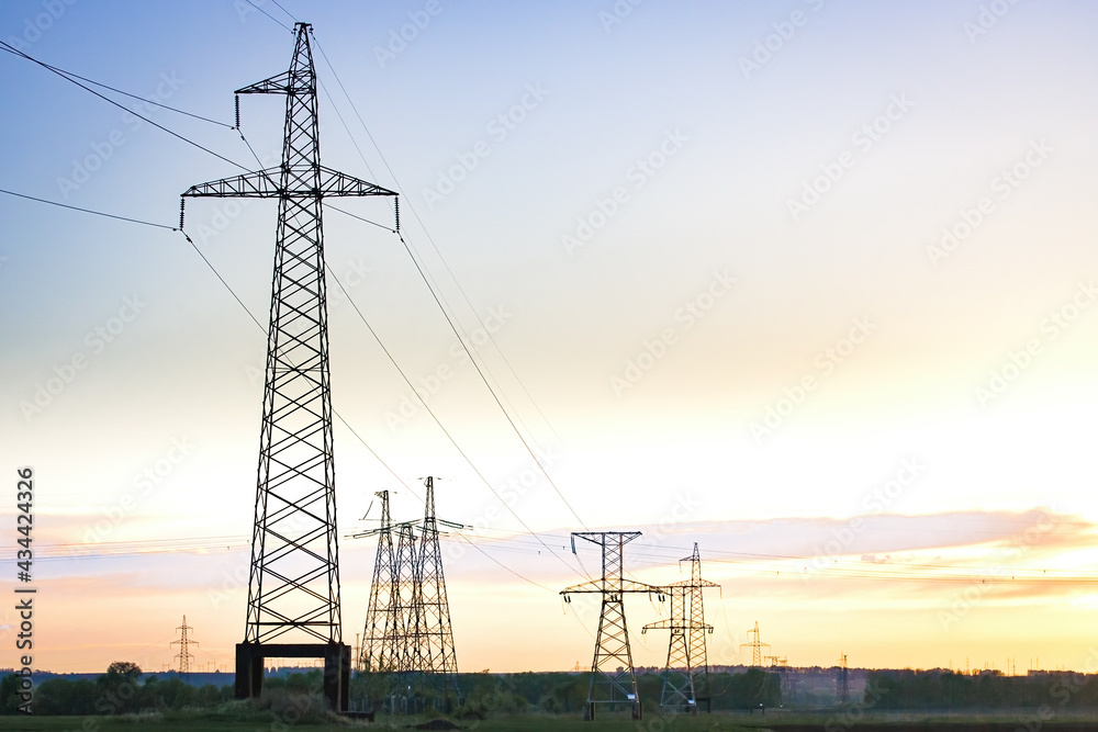 High voltage transmission on industrial electricity line tower. Energy technology with overhead power line