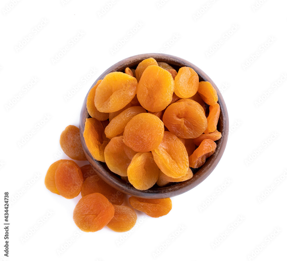Dried apricots in wooden bowl isolated on white Dried apricots in wooden bowl isolated on white