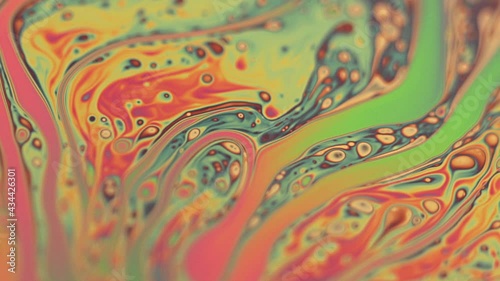 Chaotic liquid motion of psychedelic multicolored colors of soap bubble photo