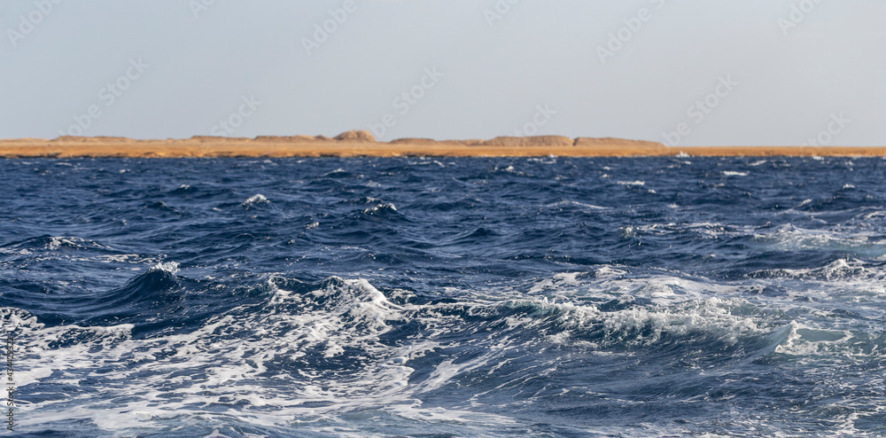 Turbulent flow of a boat wake. Sea wave. The yacht sails, leaving behind a trail and waves.