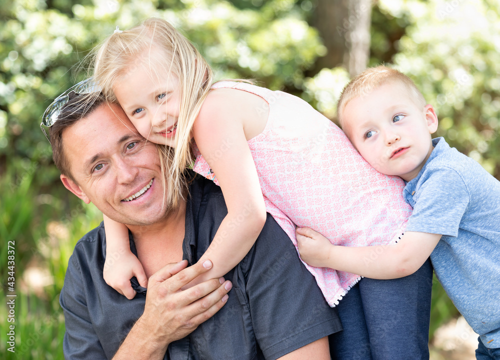 Young Caucasian Father, Daughter and Son Having Fun At The Park Young Caucasian Father, Daughter and Son Having Fun At The Park