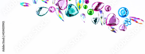 White background with colorful rhinestone gems. photo