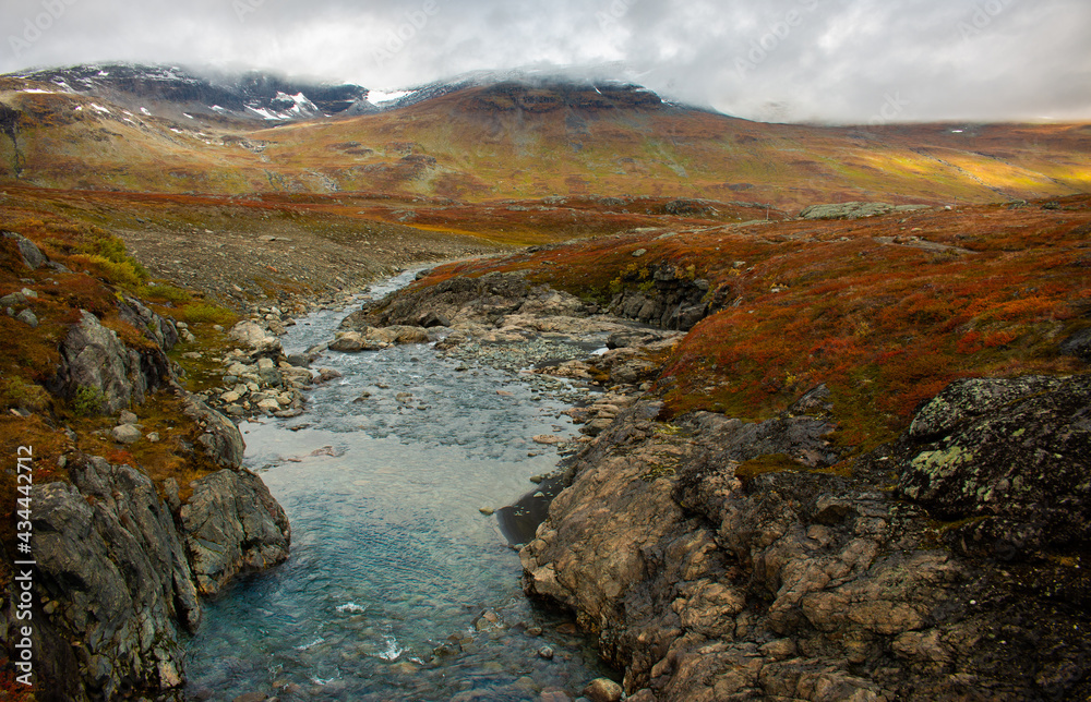 Sunrise at one of the streams crossing Kungsleden trail in September, close to Alesjaure, Swedish Lapland. Sunrise at one of the streams crossing Kungsleden trail in September, close to Alesjaure, Swedish Lapland.