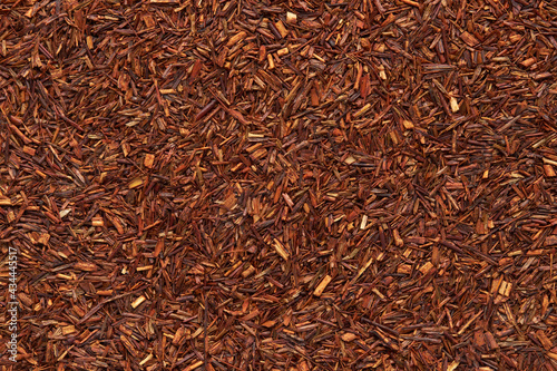 Rooibos tea texture close up. Dry redbush healthy tea, top view. photo