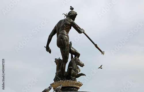Neptune's sculpture with pigeon - 17th century historic fountain in Long Market, Gdansk, Poland