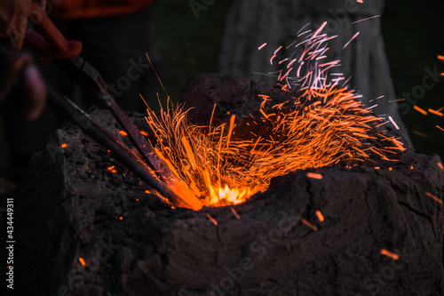 Forging outdoors and sparkles around macro 