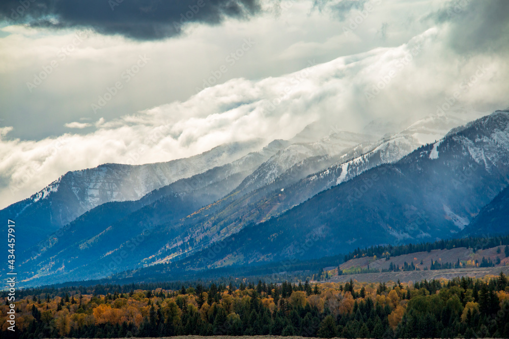 snow capped jagged peaks of the Grand teton mountain range in wyoming during autumn. snow capped jagged peaks of the Grand teton mountain range in wyoming during autumn.