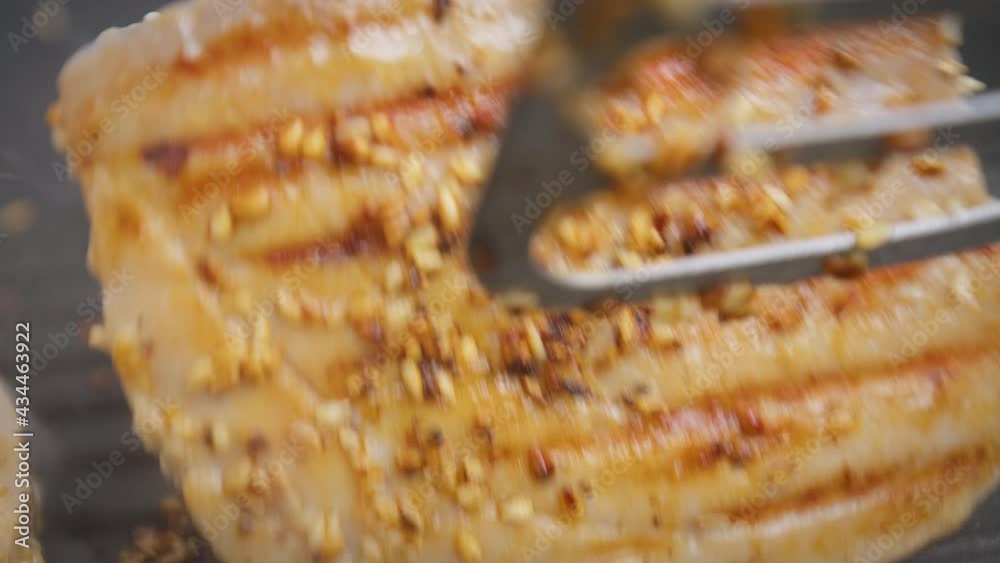 Flipping a steak of yellowfin tuna on a grilling pan in 4K. Concept