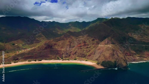 Playa De Las Teresitas. Cinematic Drone Aerial Pull Back Shot of Beach in San Andres Tenerife Canary Island Under Anaga Volcanic Mountains. White sand and azure coast of the Ocean from a height. photo
