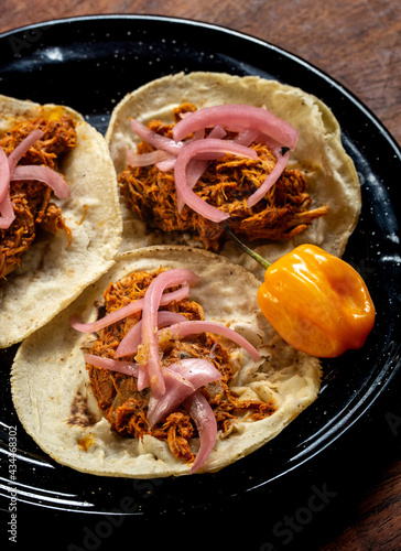 Tacos de cochinita estilo yucatán, comida mexicana tradicional con chile habanero y cebolla morada photo