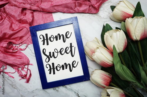 Home Sweet Home calligraphy and tulip flower flat lay on marble background