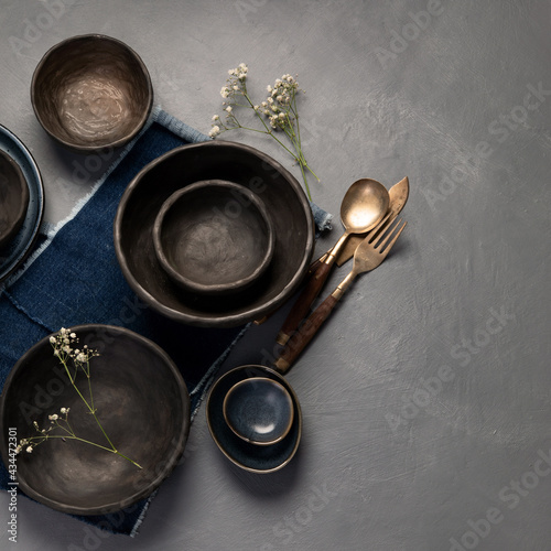 Photography Table setting with a black and blue plates on gray background
